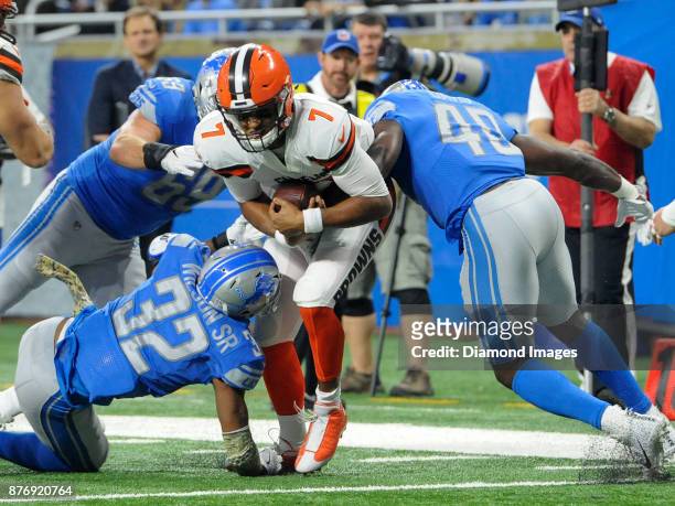 Quarterback DeShone Kizer of the Cleveland Browns is tackled by linebacker Jarrad Davis, safety Tavon Wilson and defensive end Anthony Zettel of the...
