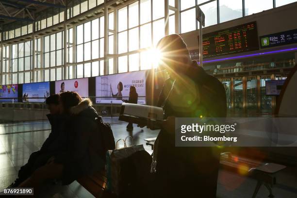 Man reads a book at Seoul Station in Seoul, South Korea, on Tuesday, Nov. 21, 2017. Visitors to the PyeongChang Winter Olympics, starting Feb. 9,...