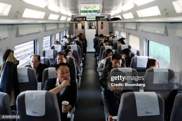 Passengers sit inside a Korea Train Express Sancheon high-speed train, manufactured by Hyundai Rotem Co., bound for Gangneung during a media tour in...