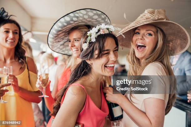 pouring champagne with friends - ladies hat stock pictures, royalty-free photos & images