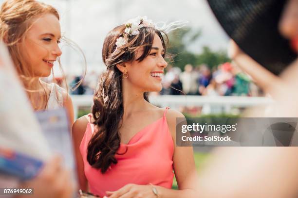 two young women on ladies day - fascinator stock pictures, royalty-free photos & images