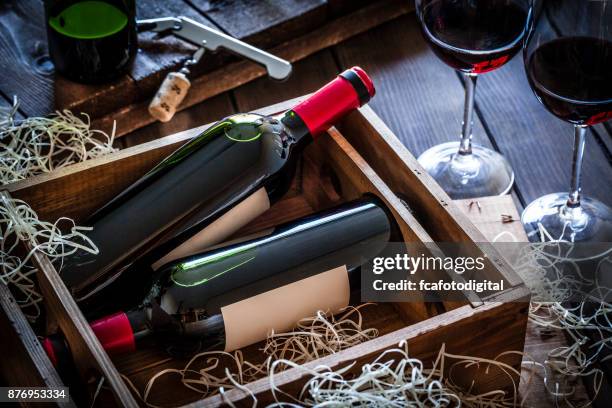 wine bottles packed in a wooden box shot rustic wooden table - wine gift stock pictures, royalty-free photos & images