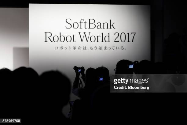 Attendees take photographs during a talk session at the SoftBank Robot World 2017 in Tokyo, Japan, on Tuesday, Nov. 21, 2017. SoftBank Chief...