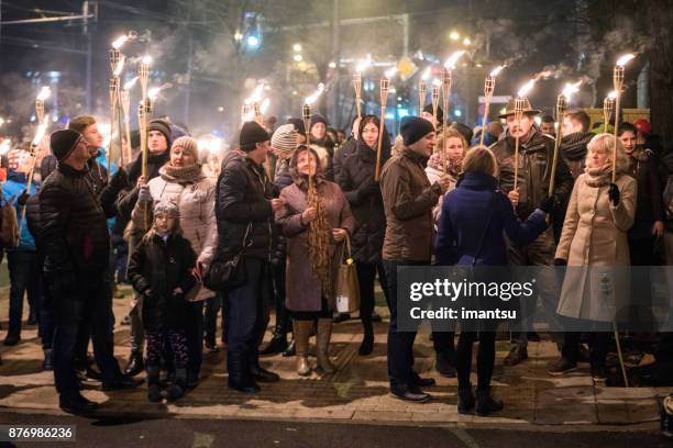 the 18 november torchlight procession - european best pictures of the day november 18 2017 stock pictures, royalty-free photos & images