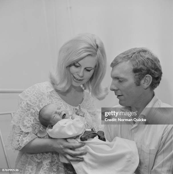 British footballer Bobby Moore and wife Tina welcome their newborn Dean, UK, 29th March 1968.