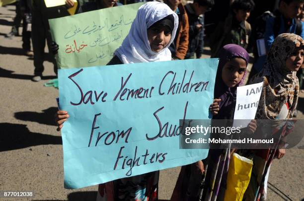Yemeni children take part in a protest outside the United Nations Office on November 20, 2017 in Sana'a, Yemen. Protestors demand the UN and the...