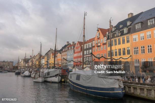 Nyhavn harbour on the 19th November 2017 in Copenhagen, Denmark. Nyhavn is a 17th-century waterfront, canal and entertainment district in Copenhagen....