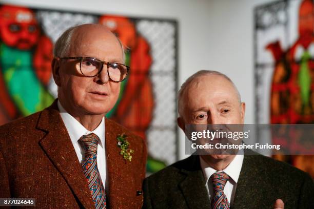 British artists Gilbert Proesch and George Passmore pose for pictures during the press preview of their latest exhibition entitled "The Beard...