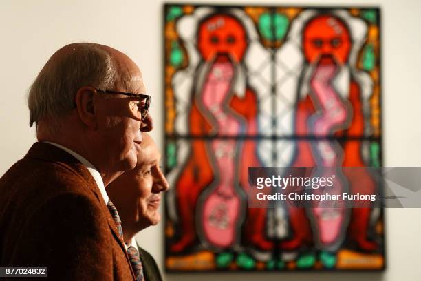 British artists Gilbert Proesch and George Passmore pose for pictures during the press preview of their latest exhibition entitled "The Beard...