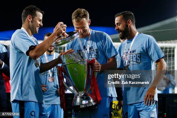 Bobo, Alex Wilkinson and Alex Brosque of Sydney celebrates after Sydney defeated Adelaide 2-1 during the FFA Cup Final match between Sydney FC and...