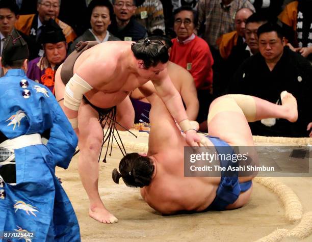 Mongolian yokozuna Hakuho throws his fellow wrestler Ichinojo to win during day ten of the Grand Sumo Kyushu Tournament at Fukuoka Convention Center...