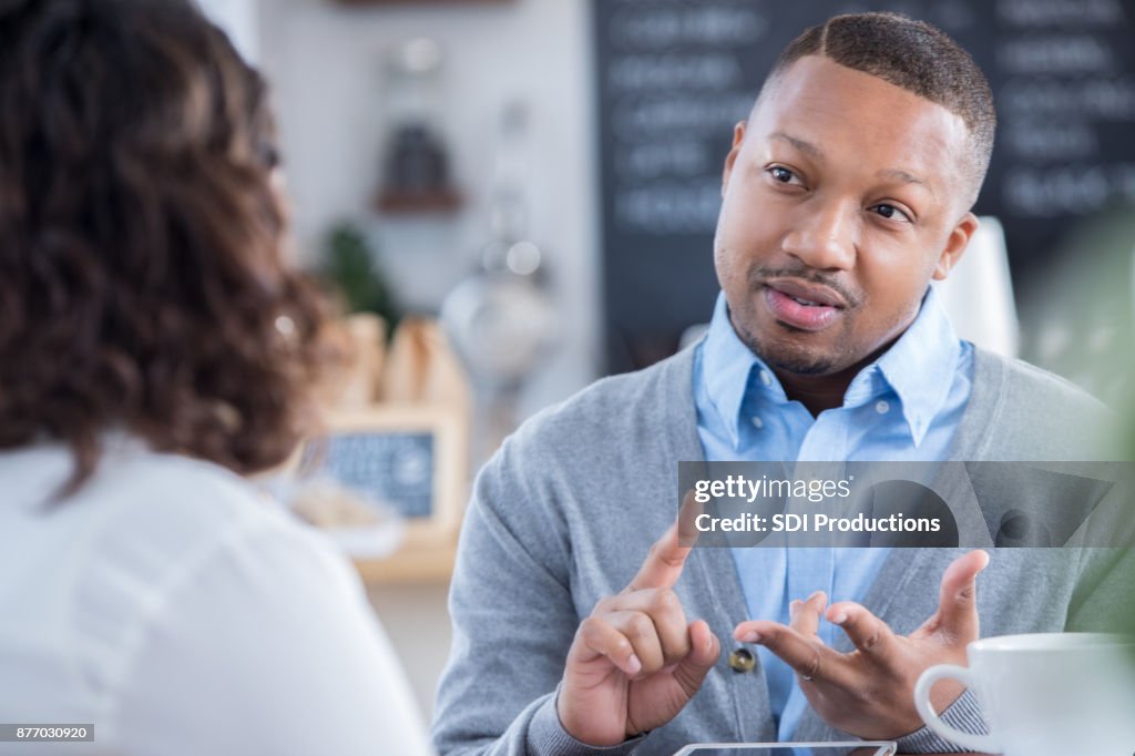 Interviewer outlines job responsibilities during coffee shop interview