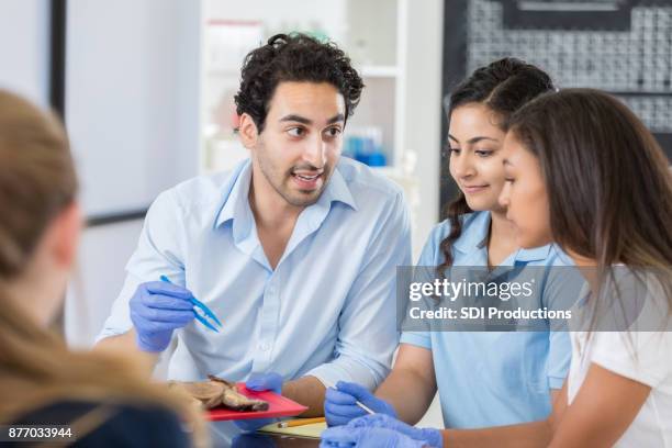 high school stem teacher talks with students before dissecting frong - frog dissection stock pictures, royalty-free photos & images
