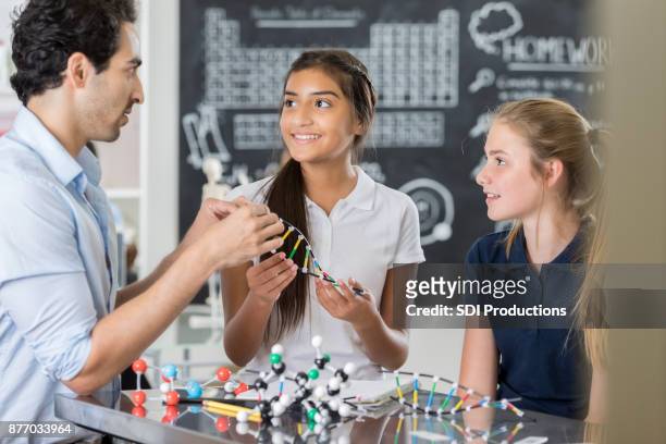 confident junior high teacher works with students in science lab - junior girl models stock pictures, royalty-free photos & images