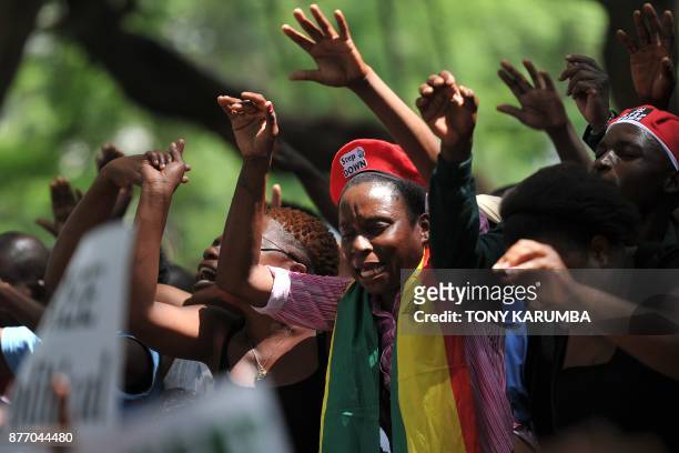 Woman wearing a flag of Zimbabwe takes part in a gathering of anti-Zimbabwe President at Unity square, on November 21, 2017 in the capital Harare,...