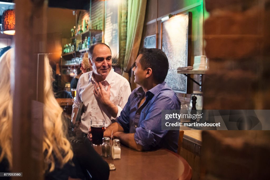 Friends and coworkers party in a bar.