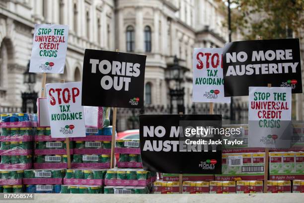 Protester stages a food bank demonstration on Whitehall complete with tons of packaged food against the Government's Universal Credit programme on...