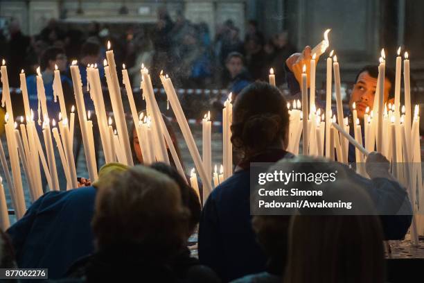 Pilgrims light candles before the holy mass at Madonna della Salute church on the day of the traditional Festa della Salute on November 21, 2017 in...