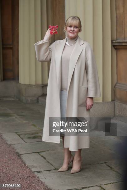 Actress Sarah Lancashire poses after she was awarded an OBE by Duke of Cambridge during an Investiture ceremony at Buckingham Palace on November 21,...