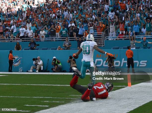 Kenny Stills of the Miami Dolphins scores a touchdown in the fourth quarter against the Tampa Bay Buccaneers at Hard Rock Stadium on November 19,...
