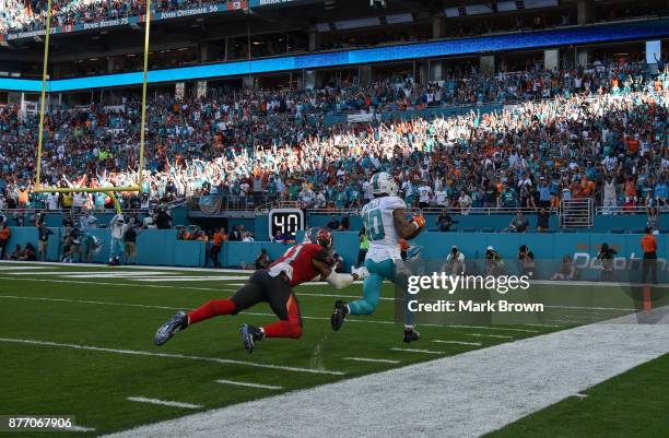 Kenny Stills of the Miami Dolphins scores a touchdown in the fourth quarter against the Tampa Bay Buccaneers at Hard Rock Stadium on November 19,...