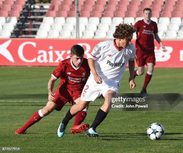 Adam Lewis of Liverpool U19 competes with Valentino Fattore Scotta of Sevilla FC U19 during the UEFA Champions League group E match between Sevilla...