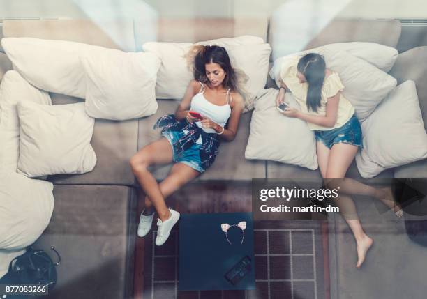 tired girls resting after arrival - lying down friends girls stock pictures, royalty-free photos & images