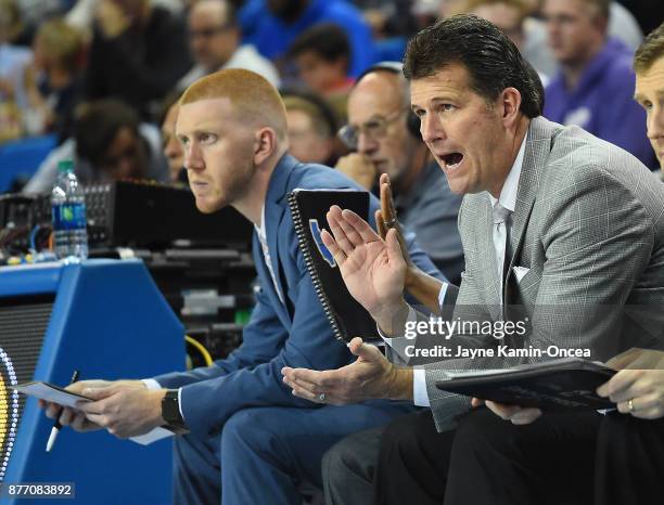 Head coach Steve Alford of the UCLA Bruins sits on the bench next to his son, video coordinator Kory Alford, during the game against the South...