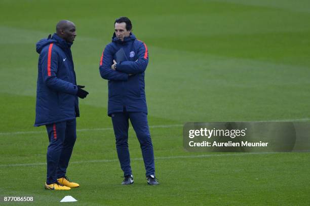 Paris Saint-Germain Head Coach Unai Emery speaks with Zoumana Camara during warm up before a Paris Saint-Germain training session at Centre Ooredoo...