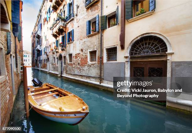 boat docked along canal in venice, italy - noble rot stock pictures, royalty-free photos & images