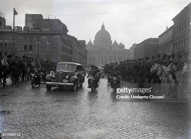 Pope Pius XII is escorted while he leaves Vatican City, 1939. He is inside the car.