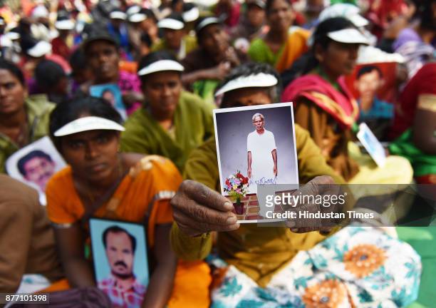Ramanamma from Andhra Pradesh, holding picture of her husband Laxmayya who committed suicide during a demonstration in support of their various long...