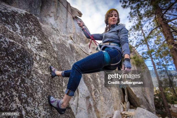 abseiling woman looking down at the ground - free falling stock pictures, royalty-free photos & images