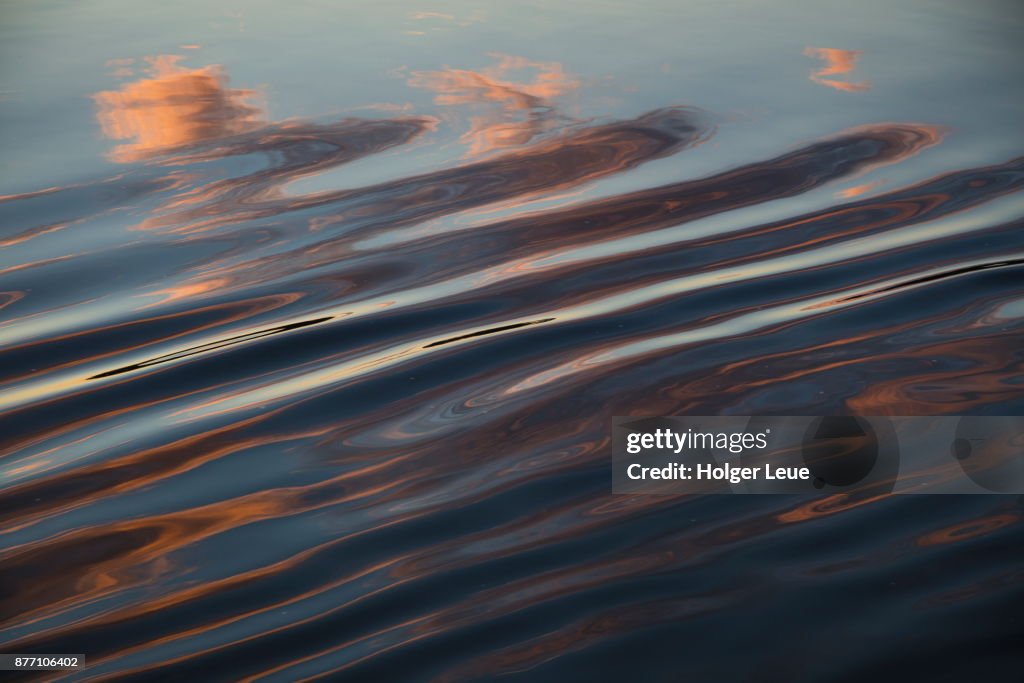 Cloud reflection in wake of river cruise ship Excellence Katharina of Reisebuero Mittelthurgau (formerly MS General Lavrinenkov) at sunset, Volga river, Russia