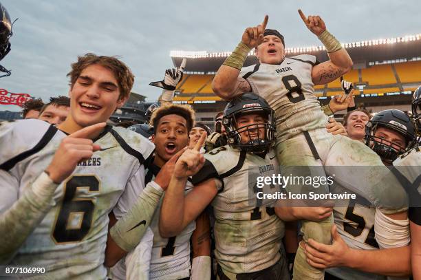 Quaker Valley seniors Ricky Guss, #8 Jordan Taylor, #1 Isaiah Mcnair, #55 Oliver Funk, and other team mates celebrate after winning the Western...