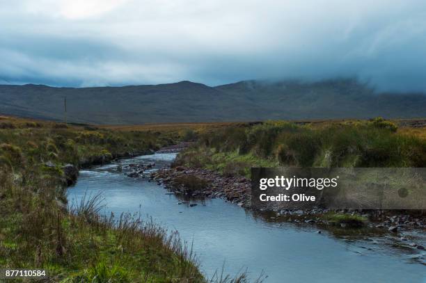 on the road to conor pass, dingle bay,river - connor pass stock pictures, royalty-free photos & images