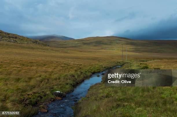on the road to conor pass, dingle bay,river - connor pass stock pictures, royalty-free photos & images