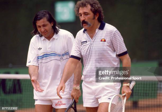 Veteran tennis players and doubles partners Ilie Nastase and Ion Tiriac both of Romania leave the court during the Italian Open Tennis Championships...