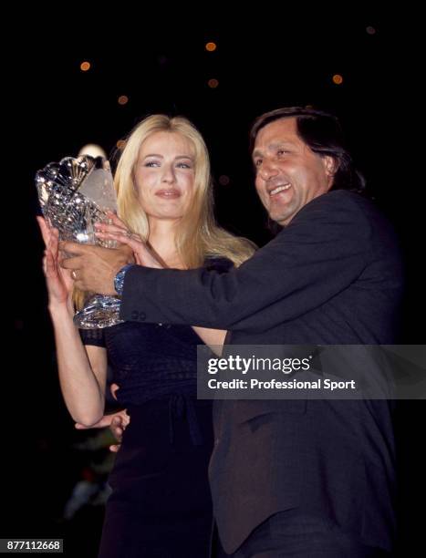 Retired tennis player Ilie Nastase of Romania with Dutch model Karen Mulder at an awards event during the Monte Carlo Open at the Monte Carlo Country...