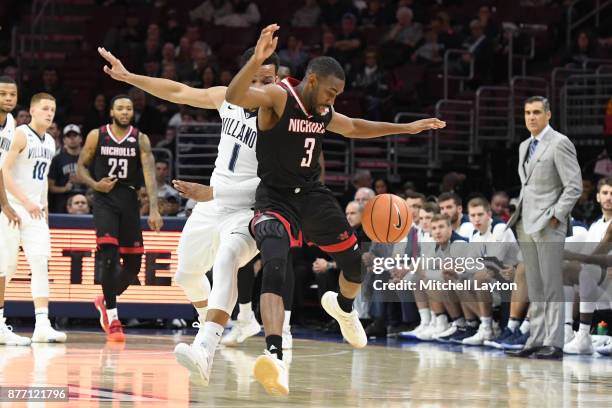 Jalen Brunson of the Villanova Wildcats and Lafayette Rutledge of the Nicholls State Colonels go after a loose ball during a college basketball game...