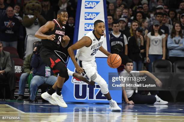 Mikal Bridges of the Villanova Wildcats dribbles up court past Lafayette Rutledge of the Nicholls State Colonels during a college basketball game at...