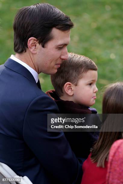 Jared Kushner, senior advisor and son-in-law to U.S. President Donald Trump, holds his son Joseph Kushner before the pardoning ceremony for the...