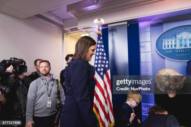 White House Press Secretary Sarah Sanders watches her 4 1/2-year-old son Huck help Wishbone back in his crate. Wishbone is one of the turkeys who may...