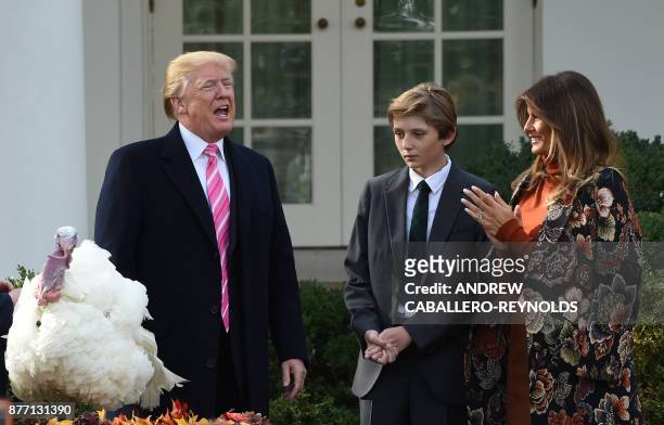 President Donald Trump speaks after he pardoned the turkey, Drumstick, as First Lady Melania Trump and their son Barron look on during the turkey...