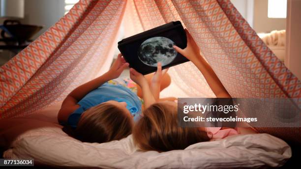 girls using digital tablet. - solar system mobile stock pictures, royalty-free photos & images