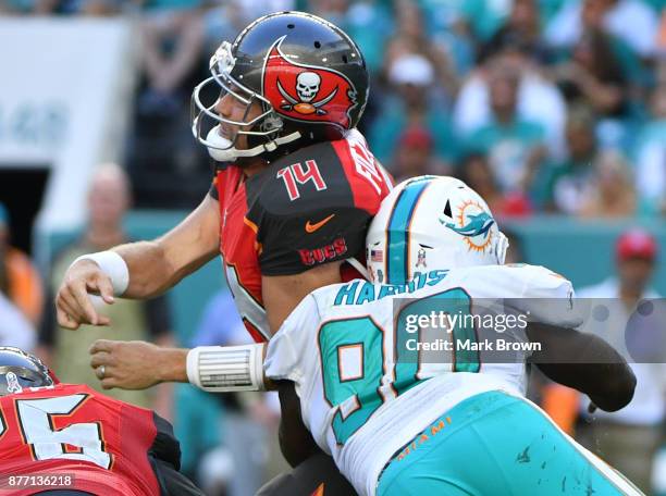 Ryan Fitzpatrick of the Tampa Bay Buccaneers hit by Charles Harris of the Miami Dolphins in the third quarter at Hard Rock Stadium on November 19,...