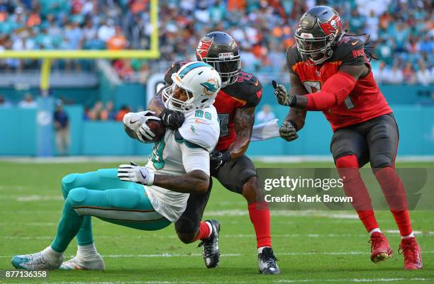 Julius Thomas of the Miami Dolphins makes the catch in the third quarter against the Tampa Bay Buccaneers at Hard Rock Stadium on November 19, 2017...