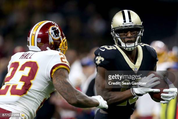 Michael Thomas of the New Orleans Saints is tackled by DeAngelo Hall of the Washington Redskins during a NFL game at the Mercedes-Benz Superdome on...