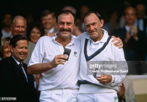 Veteran tennis players John Newcombe and Tony Roche both of Australia with their runners-up medals after losing the Men's Over-45 Doubles Final Marty...