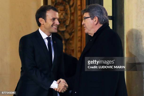 French leftist La France Insoumise party leader Jean-Luc Melenchon shakes hands with French President Emmanuel Macron as he leaves after their...